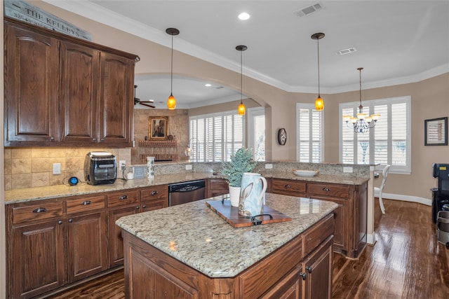 kitchen featuring arched walkways, visible vents, a center island, and stainless steel dishwasher