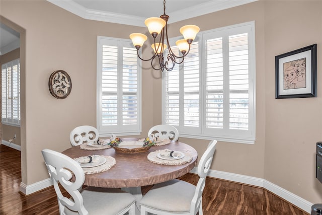 dining space featuring a chandelier, wood finished floors, baseboards, and ornamental molding