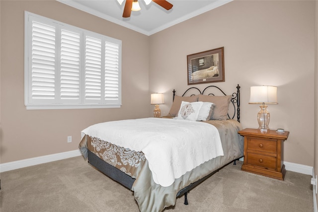 carpeted bedroom featuring crown molding, baseboards, and a ceiling fan