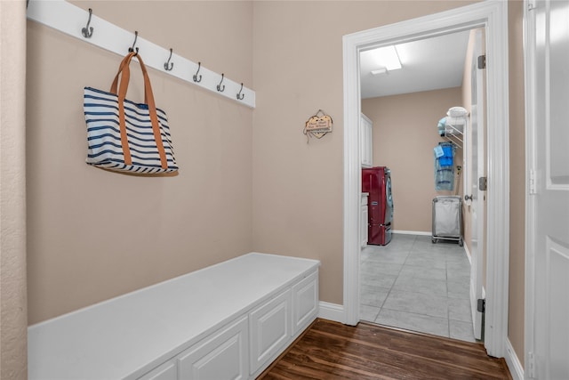 mudroom featuring baseboards and dark wood-type flooring