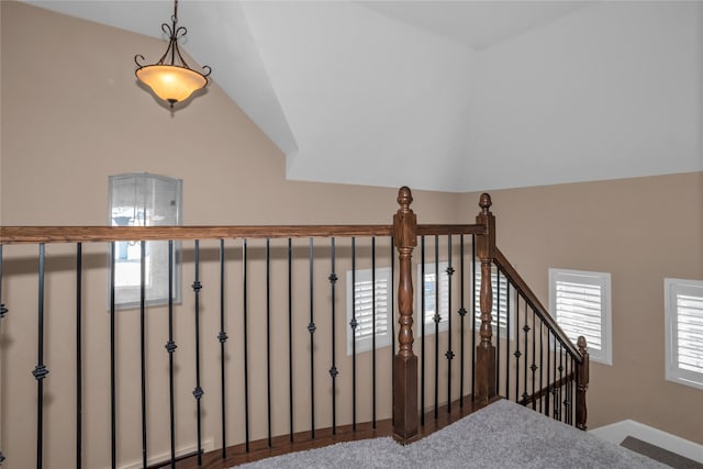 staircase featuring lofted ceiling and a healthy amount of sunlight