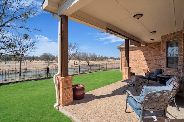 view of patio / terrace featuring fence and a water view