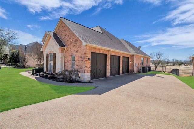 view of side of property with brick siding, a yard, roof with shingles, an attached garage, and stone siding