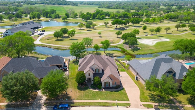 birds eye view of property with golf course view, a residential view, and a water view