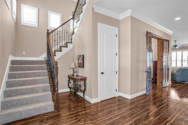stairway with baseboards, wood finished floors, recessed lighting, and crown molding