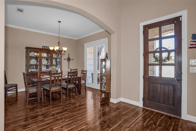 entrance foyer with arched walkways, baseboards, a healthy amount of sunlight, and dark wood-style floors