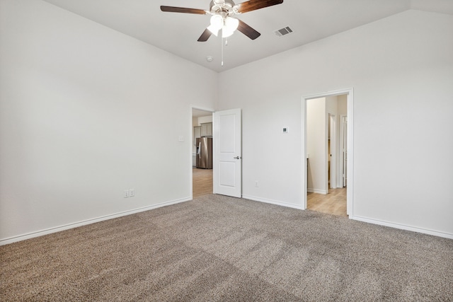 unfurnished bedroom featuring light colored carpet, a ceiling fan, baseboards, visible vents, and stainless steel fridge