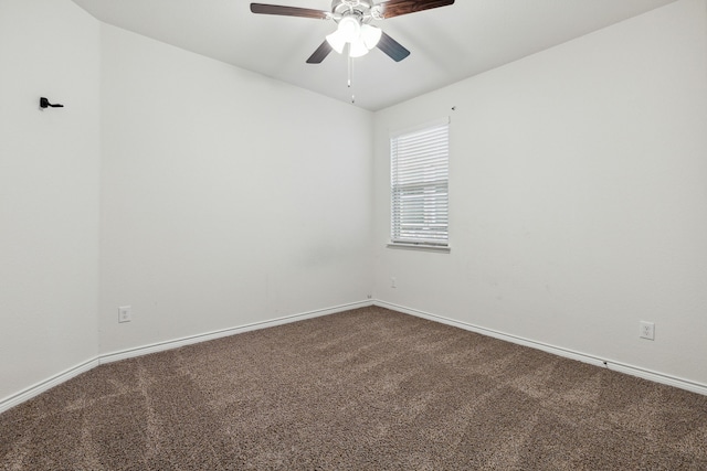 carpeted empty room with baseboards and a ceiling fan