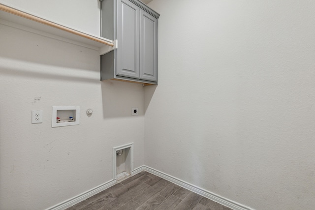 laundry area featuring dark wood-style floors, hookup for a washing machine, gas dryer hookup, electric dryer hookup, and baseboards