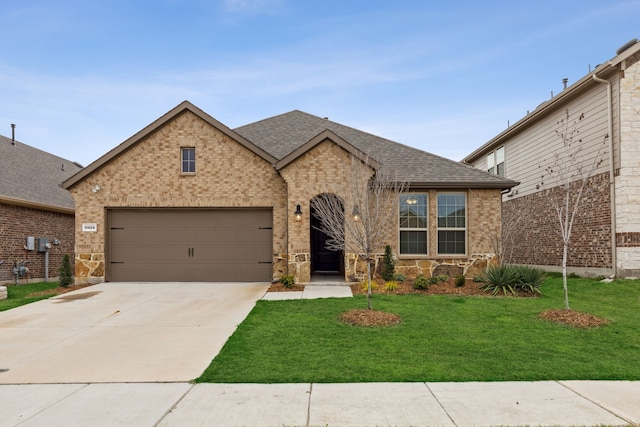 view of front of house featuring an attached garage, brick siding, concrete driveway, roof with shingles, and a front yard