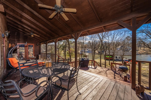 wooden terrace with ceiling fan and outdoor dining space