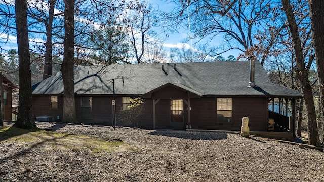 view of front facade with roof with shingles