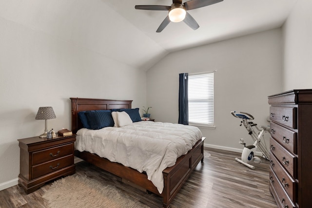 bedroom featuring a ceiling fan, lofted ceiling, wood finished floors, and baseboards