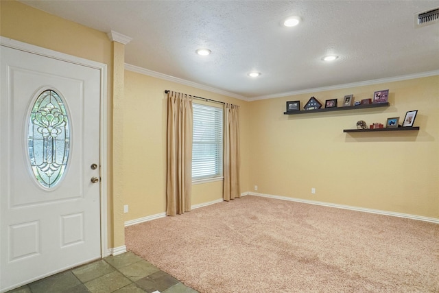 foyer featuring a textured ceiling, visible vents, baseboards, dark colored carpet, and crown molding