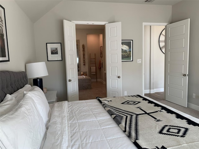 bedroom featuring visible vents, vaulted ceiling, and baseboards