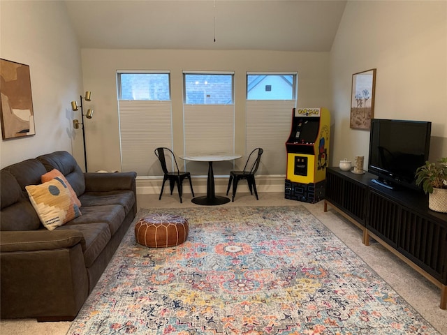 carpeted living room with vaulted ceiling and baseboards