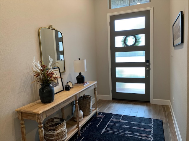 foyer with wood finished floors and baseboards