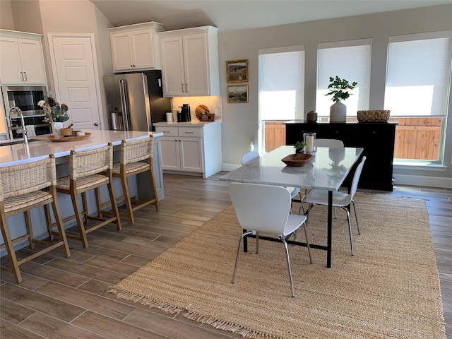 dining area with wood finished floors