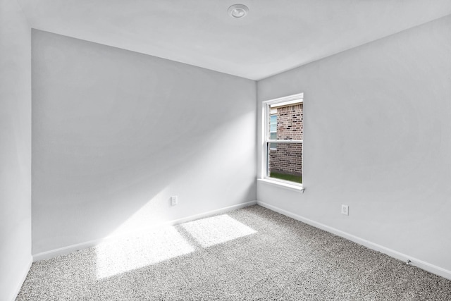 spare room with carpet flooring and baseboards