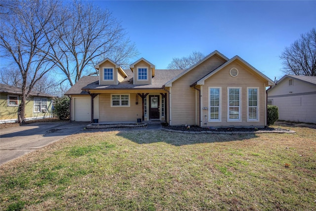 view of front of house featuring concrete driveway, an attached garage, and a front yard