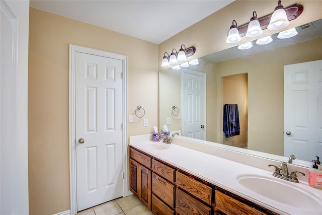 bathroom featuring tile patterned flooring, visible vents, a sink, and double vanity