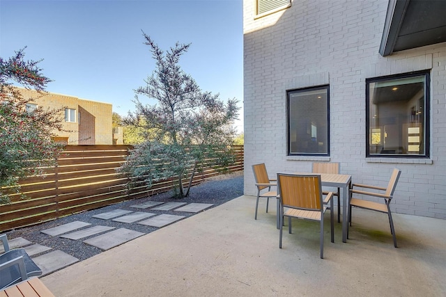 view of patio featuring fence and outdoor dining area