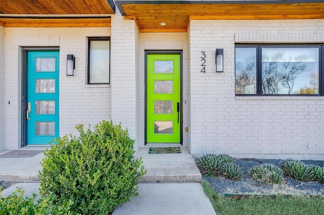 doorway to property with brick siding