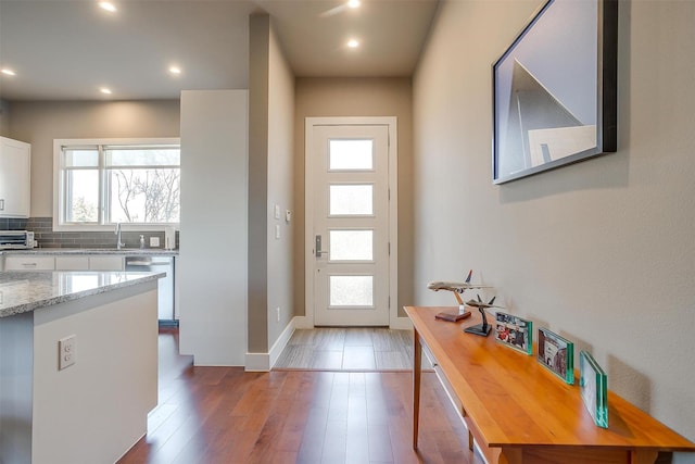 entrance foyer featuring baseboards, a toaster, wood finished floors, and recessed lighting