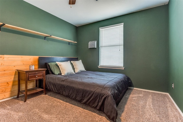 carpeted bedroom featuring ceiling fan and baseboards