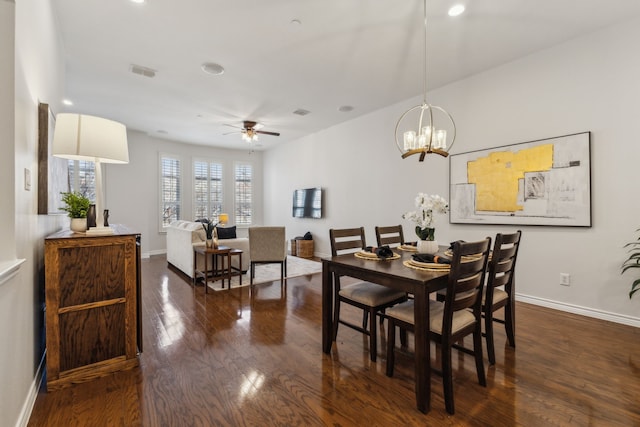 dining area with baseboards, recessed lighting, dark wood-style floors, visible vents, and ceiling fan with notable chandelier