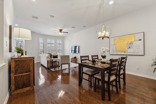 dining space with ceiling fan, dark wood-type flooring, visible vents, and baseboards