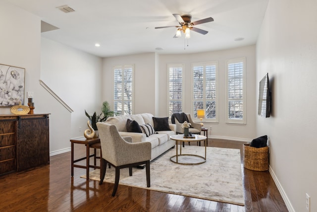 living area with ceiling fan, baseboards, dark wood finished floors, and visible vents