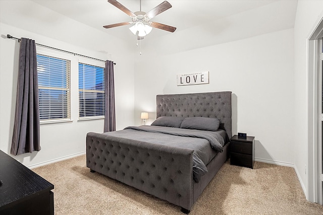 bedroom with baseboards, ceiling fan, and light colored carpet