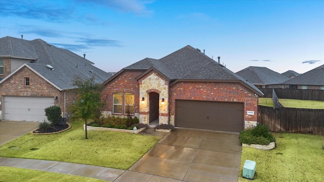 view of front of home with brick siding, a shingled roof, stone siding, fence, and a front yard