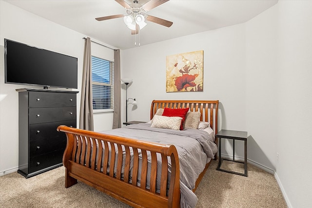 bedroom with baseboards, a ceiling fan, and light colored carpet