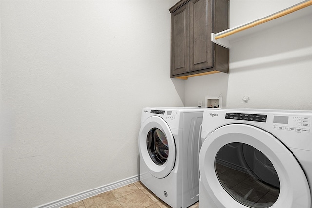 laundry area with cabinet space, light tile patterned floors, baseboards, and independent washer and dryer