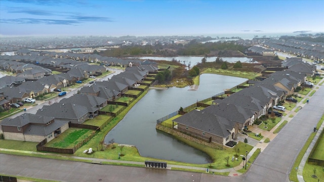 birds eye view of property featuring a water view and a residential view