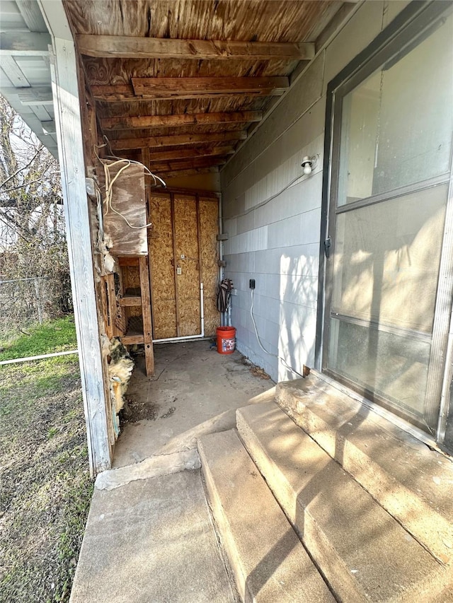 exterior space featuring concrete floors and concrete block wall