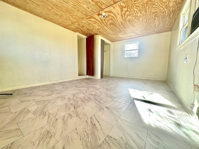 unfurnished room with wood ceiling