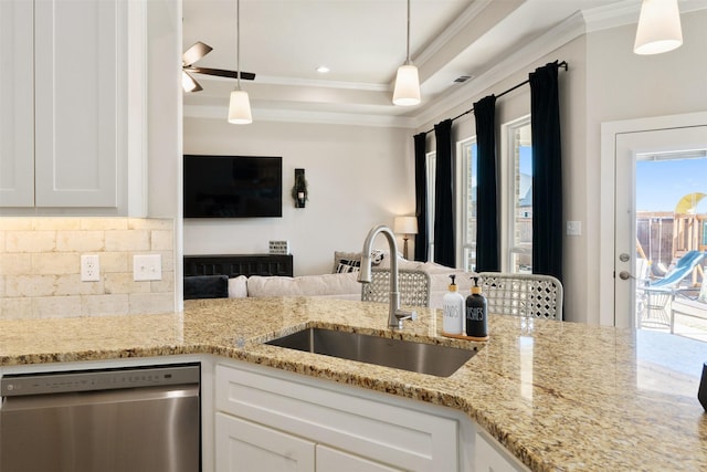 kitchen with hanging light fixtures, a sink, white cabinets, and dishwasher