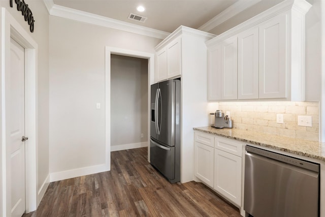 kitchen with light stone countertops, appliances with stainless steel finishes, and white cabinets