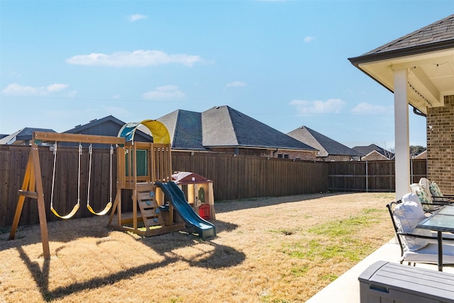 view of yard featuring a fenced backyard and a playground