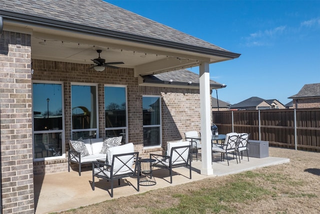 view of patio / terrace with fence, an outdoor living space, and a ceiling fan