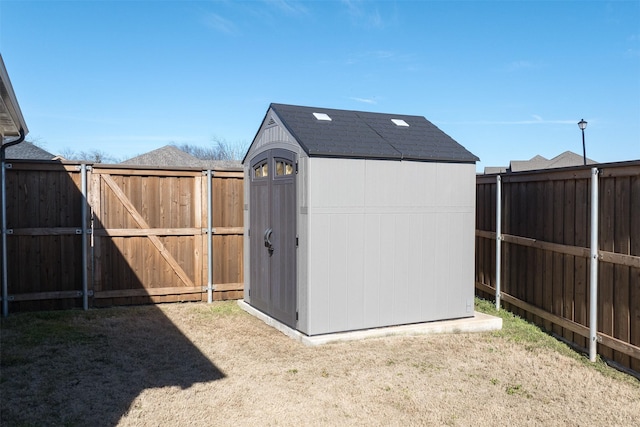 view of shed with a fenced backyard