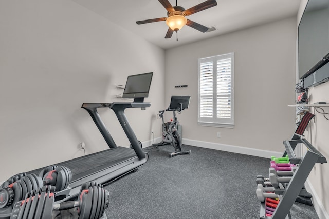 workout area with ceiling fan and baseboards