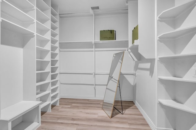 walk in closet with visible vents and wood finished floors