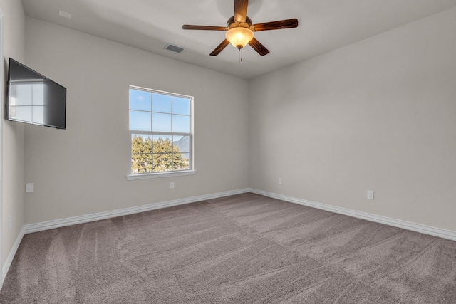 unfurnished room with baseboards, visible vents, ceiling fan, and carpet flooring