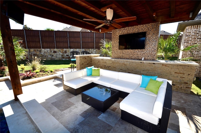 view of patio / terrace with a ceiling fan, fence, and an outdoor hangout area