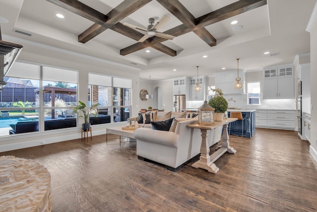 living room with dark wood-style floors, beam ceiling, visible vents, ceiling fan, and coffered ceiling