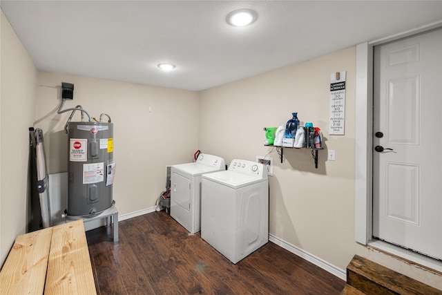 clothes washing area featuring laundry area, baseboards, dark wood-style floors, washing machine and dryer, and water heater